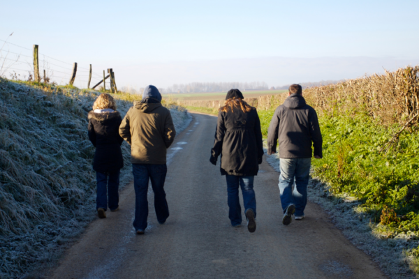 Four people walking along a path